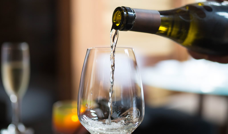 White wine pouring in glass